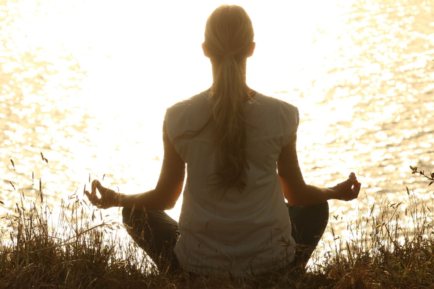 Woman-alone-meditating-back-to-camera